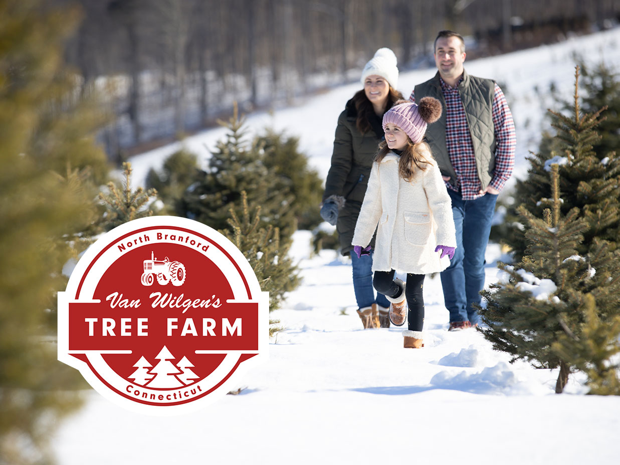 family walking through farm with snow on ground